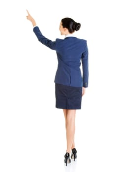 Happy young business woman pointing on copy space, isolated on white