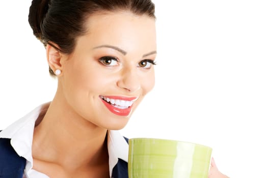 Smiling businesswoman having coffee / tea break isolated on white background