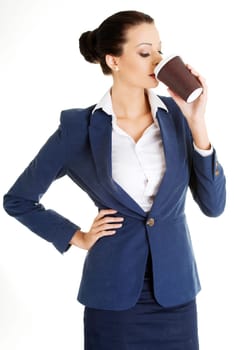 Cofee brake in rush day. Business woman drinking cofee or tea from paper cup.