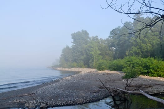 Mist over the lake and sunshine and blue sky..