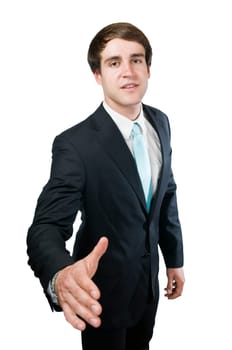 Upper body shot of a young manager with his hand extended to the camera smiling into the camera to greet him,in front of a white background