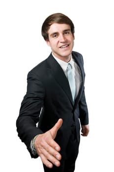 Upper body shot of a young manager with his hand extended to the camera smiling into the camera to greet him,in front of a white background