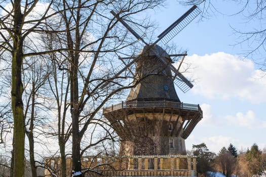 Old wind mill at the winter forest landscape in Germany