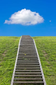 Staircase to the sky. Huge stairway leading up a green hill