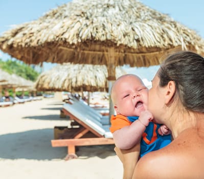 Baby and mom are relaxing on sunbed