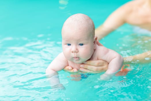 Adorable baby in swimming pool