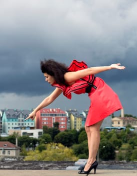 Woman in nice dress pointing on house window