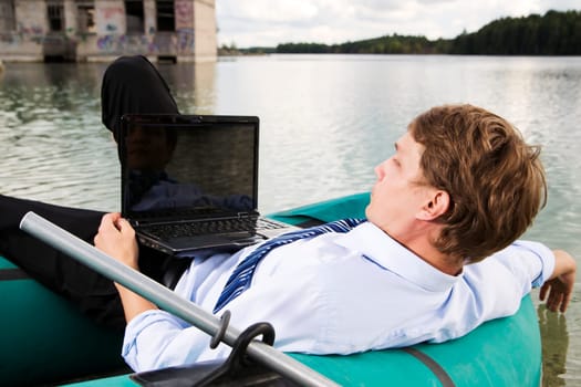 Man in costume lay over boat on lake