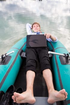 Dressed man lay in boat and take time