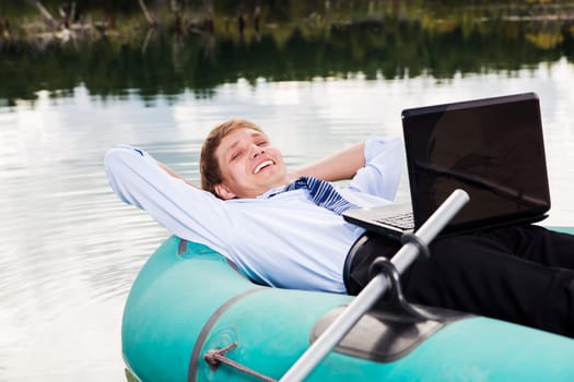 Satisfied man lay in boat and take time