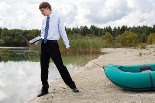 Dressed man plan drags boat at lake surface