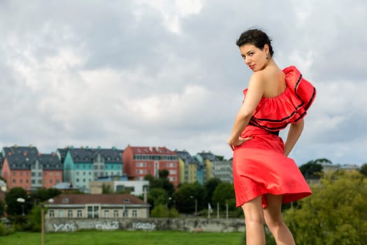 Woman in nice dress posing at windy weather