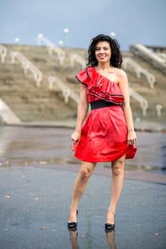 Woman in nice soaking wet dress is smiling