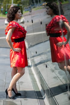 Woman in soaking wet dress posing before reflection