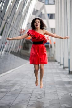 Woman in nice soaking wet dress jump on square