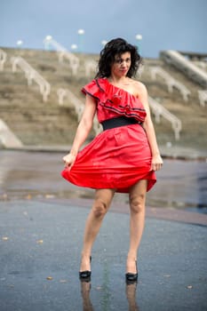 Woman in nice soaking wet dress at square