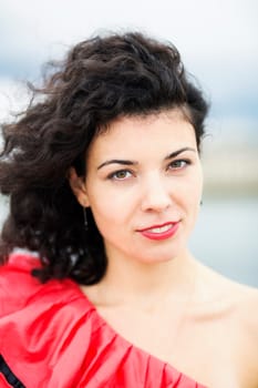Portrait of nice looking woman in red dress