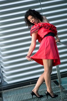 Woman in nice dress stretches her red skirt