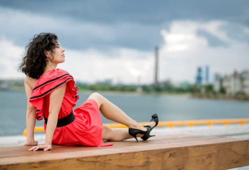 Woman in red dress leisure at city background