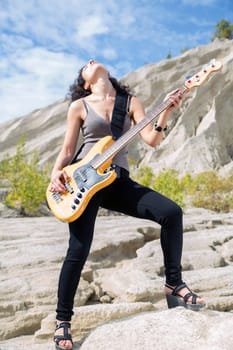 Woman feel great playing on yellow bass guitar