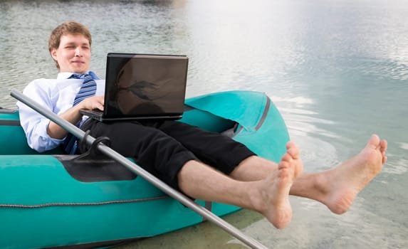 Dressed man lay over boat and prints message