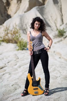 Woman placed yellow guitar on ground between legs