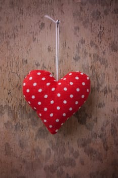 red fabric hearts with wood background