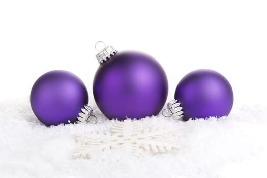 Christmas baubles purple with star on artificial snow