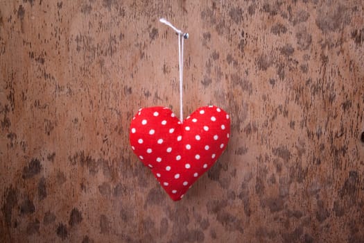 red fabric heart with wooden background for special occasions