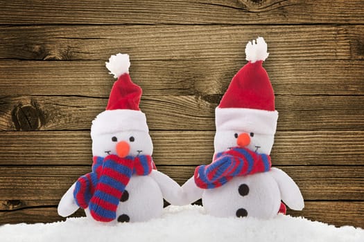Snowmen with wooden background