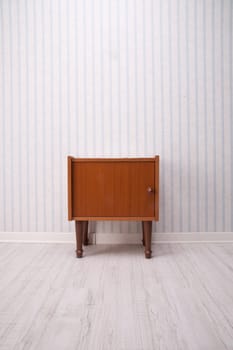 piece of furniture with old fashioned striped wallpaper