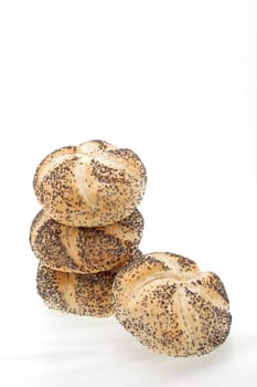 A stack of poppy seed rolls on a white background