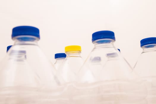 Empty bottles of mineral water, one with a different lid.