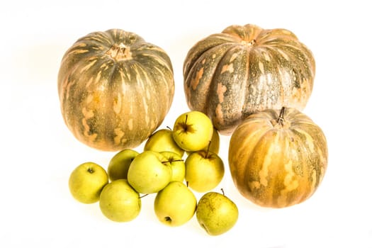 Pumpkins and green apples on a white background, isolated.
