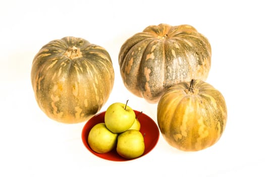Pumpkins and green apples on a white background, isolated.