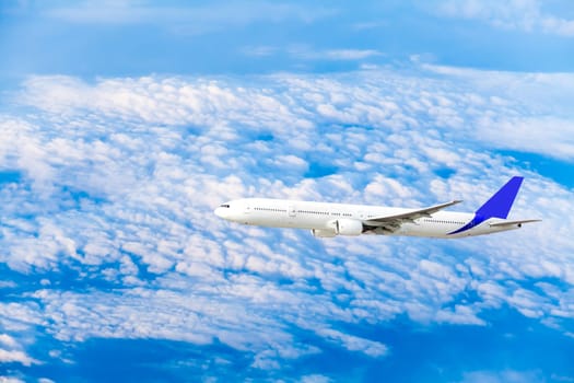 Airplane at fly on the sky with clouds