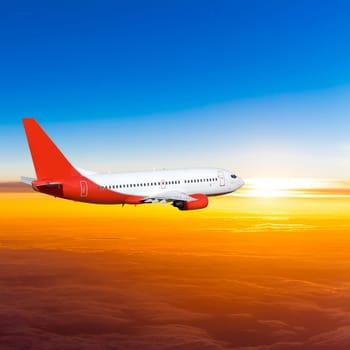 Airplane in the sky at sunset. A passenger plane in the sky