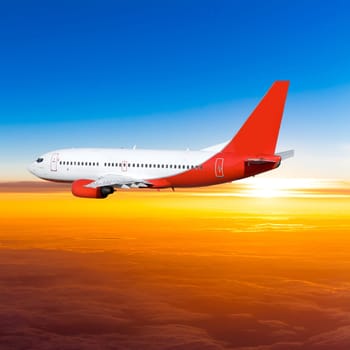 Airplane in the sky at sunset. A passenger plane in the sky