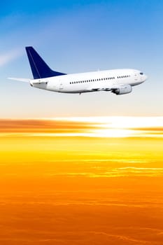 Airplane in the sky at sunset. A passenger plane in the sky