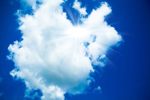 Blue sky with clouds and sun. White clouds in blue sky