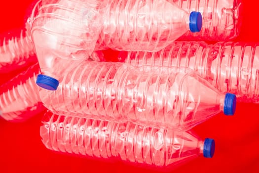 Empty bottles of mineral water, with a red background.