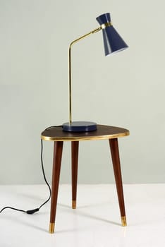 Vintage blue lamp over a wooden stool