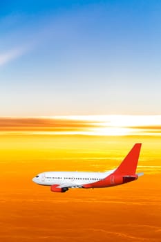 Airplane in the sky at sunset. A passenger plane in the sky