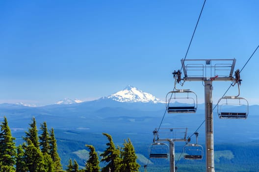 View of chairlifts on Mt. Hood with Mount Jefferson in the background in Oregon