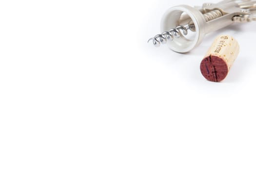 Wine cork and corkscrew on white background