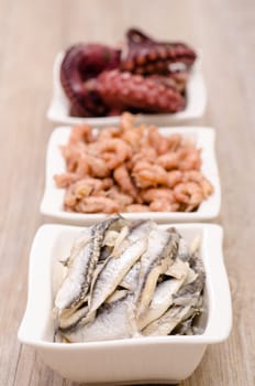 Antipasti anchovies in a white bowl of porcelain
