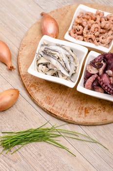 Seafood appetizers with onions and chives in portrait format