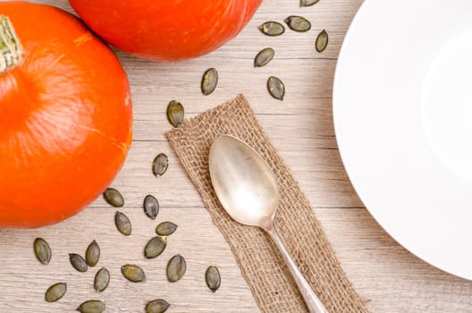 Dining table with cracks,seeds,spoons and plates