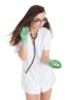 woman doctor with pills in hand. Female doctor holding many pills in her hands