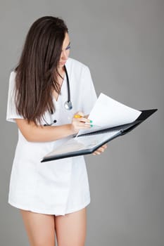 medical doctor woman with stethoscope. A female doctor with a folder